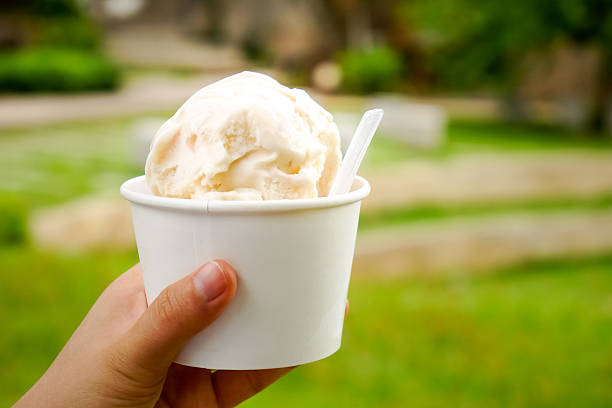 istock Ice cream. Vanilla and dairy ice cream in hand 585179152