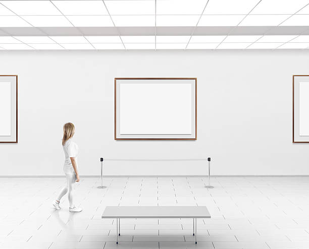 istock Woman walk in museum hall blank wall with frames 585179326