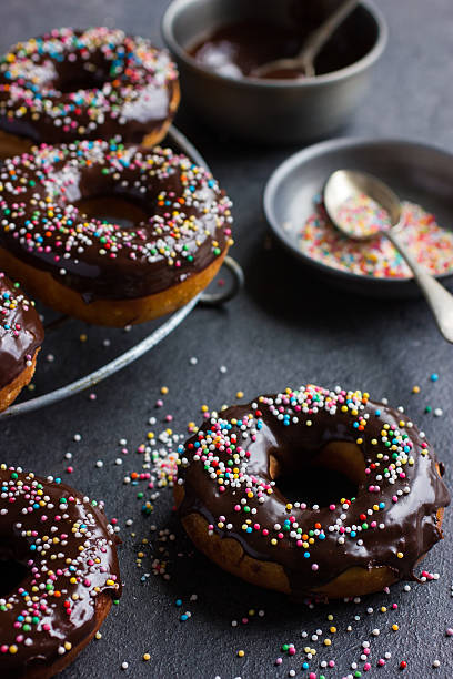 istock fresh chocolate donuts with chocolate glaze  and colorful sprink 585179898
