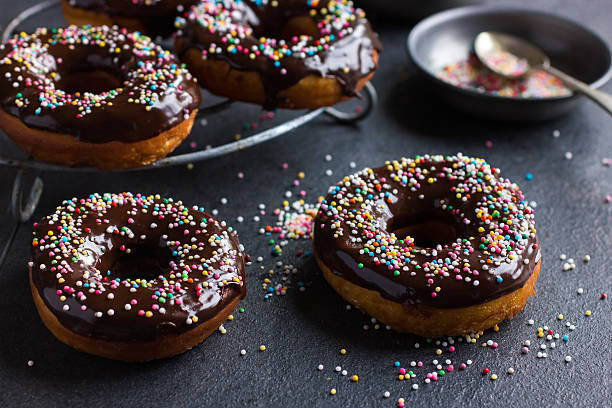 istock fresh chocolate donuts with chocolate glaze  and colorful sprink 585180458