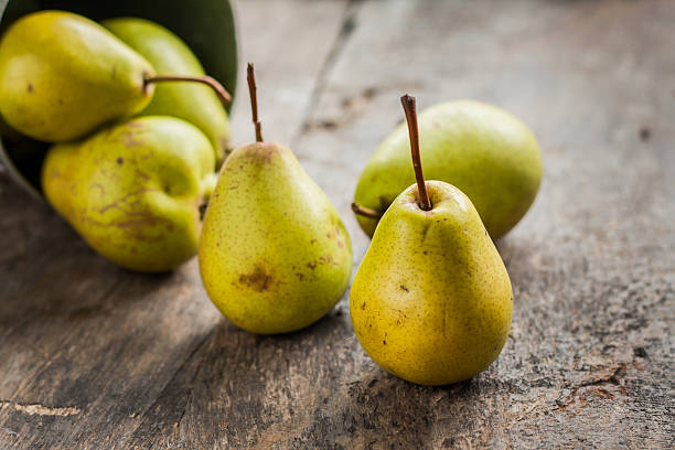 istock pears in a bucket on a rustic wooden table background 585180876