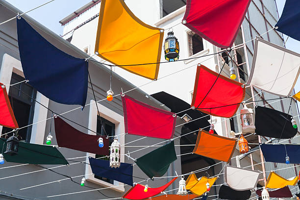 istock Colorful flags and street lamps 585180986