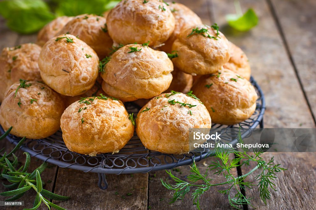 Gougeres. Traditional french cheese choux bun Gougeres. Traditional french cheese choux buns. wooden background. Gougere Stock Photo