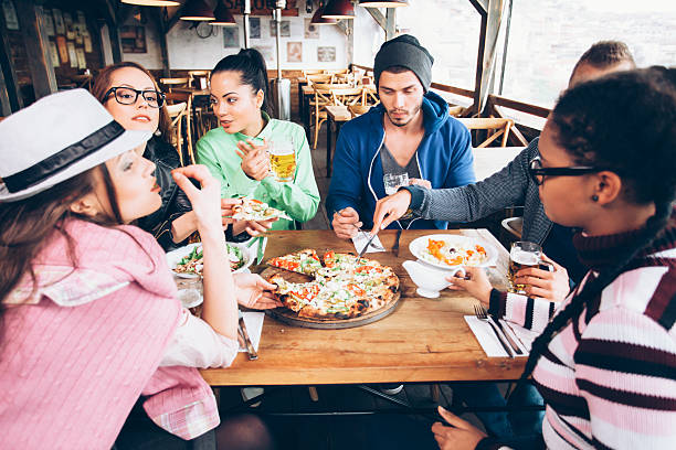 istock Young people dining together in a restaurant 585181604