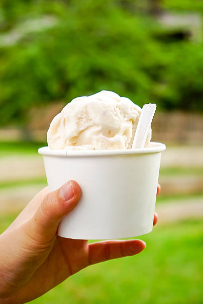 istock Ice cream. Vanilla and dairy ice cream in hand 585182468