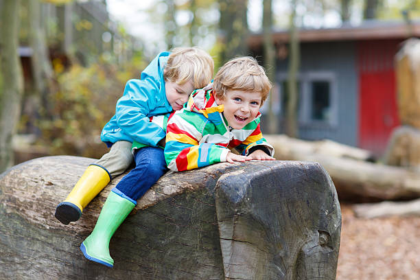 istock Two little kid boys having fun on autumn playground 585183324