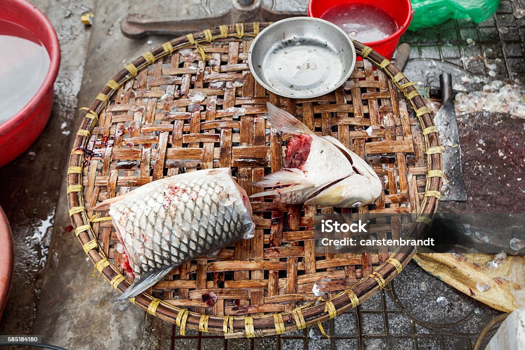 Freshly prepared fish Freshly slaughtered fish placed at a woven tray at a fishmongers street shop in Hanoi, Vietnam. Animal Scale Stock Photo