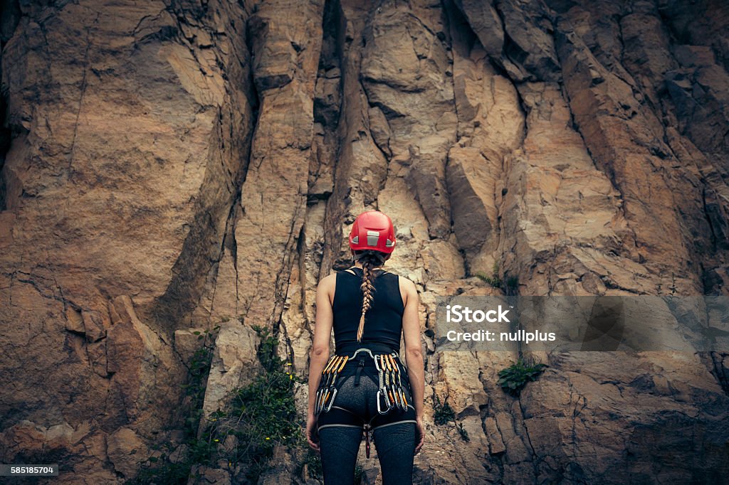 Young climber getting ready for rock climbing Climbing Stock Photo
