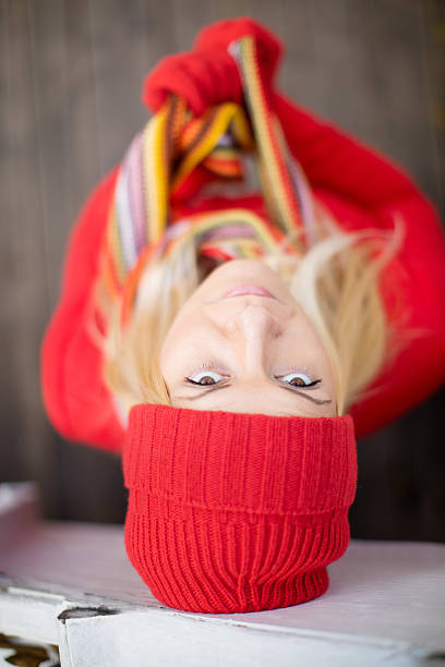 WBeautiful woman dressed in red coat and matching knit hat and mittens