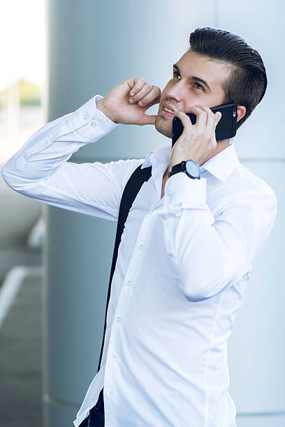 istock Handsome man on the mobile phone in hall station 585186554