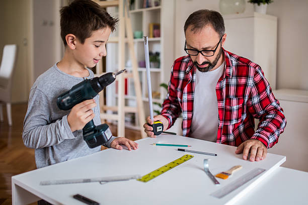 istock Father with son carpenters at home 585190288