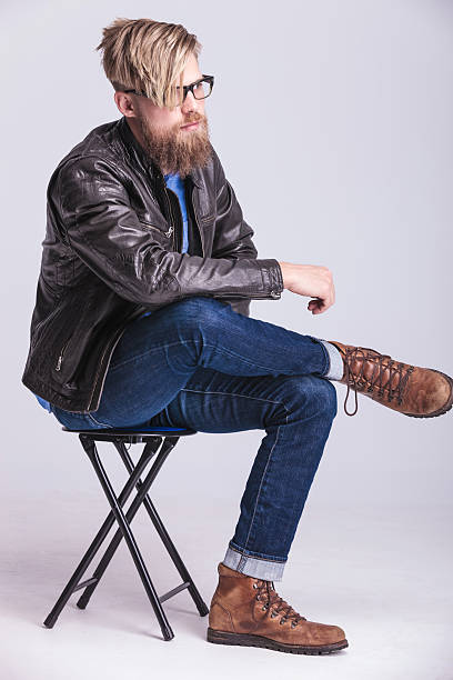 istock Casual young man relaxing on a chair 585190750