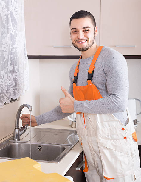 istock Plumber working at home of client 585191078