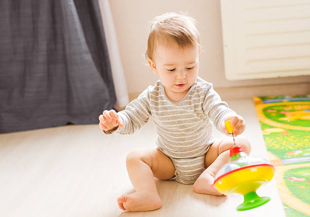 istock baby boy playing with toy indoors at home 585191930