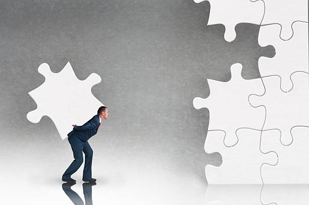 istock business puzzle concept with businessman and jigsaw 585192120