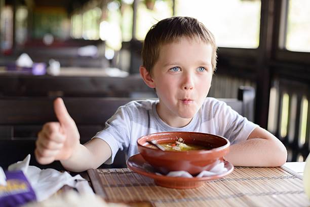 istock Little child boy enjoying his delicious soup 585193064