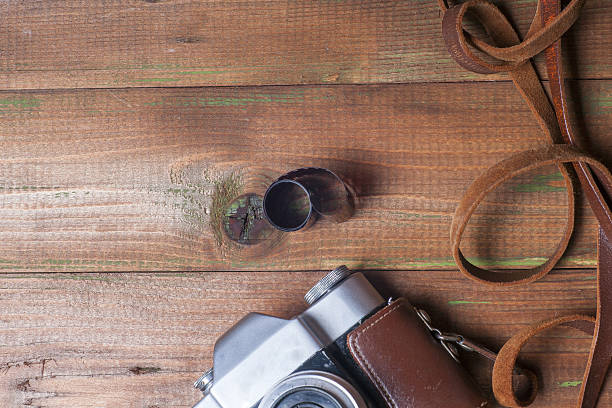 istock Old retro camera on vintage wooden boards abstract background. 585282034