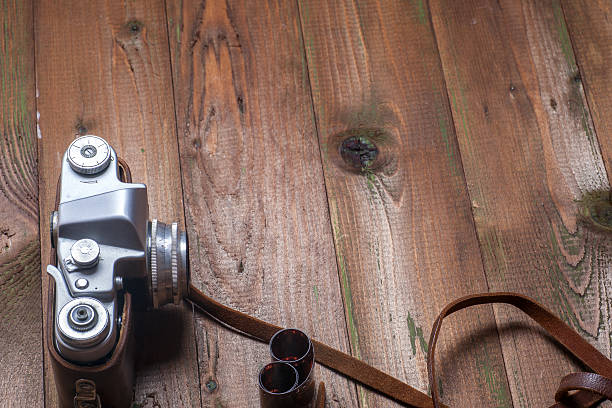istock Old retro camera on vintage wooden boards abstract background. 585282184