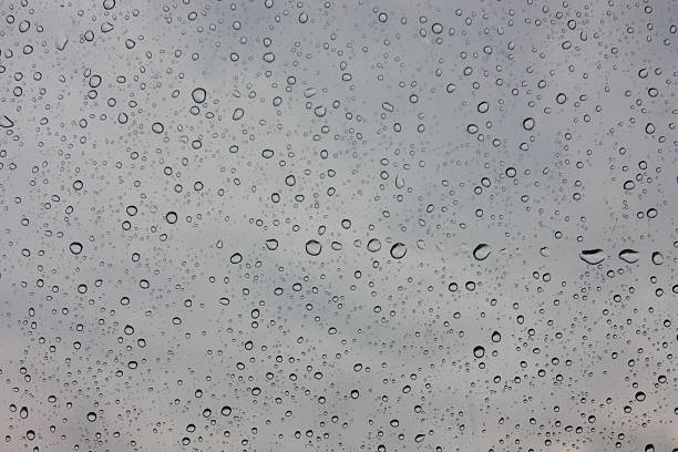 istock Drops of rain on glass , rain drops on clear window 585282606