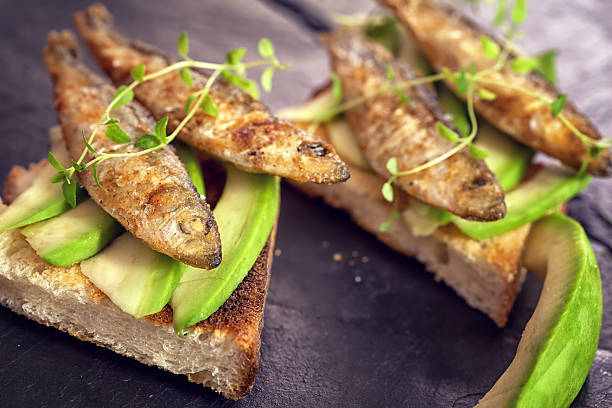 istock Sandwich with sprats and avocado 585282734