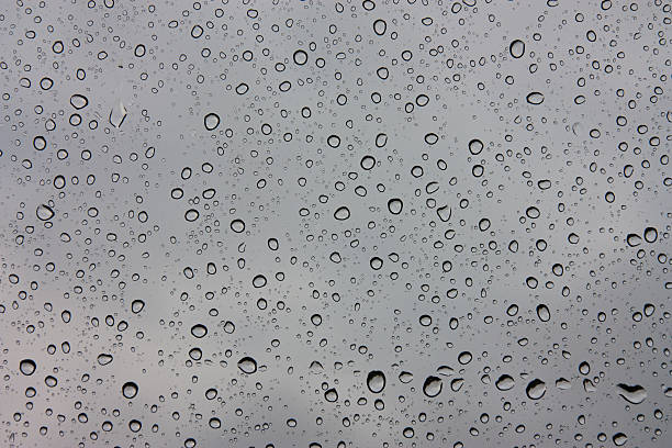 istock Drops of rain on glass , rain drops on clear window 585283140