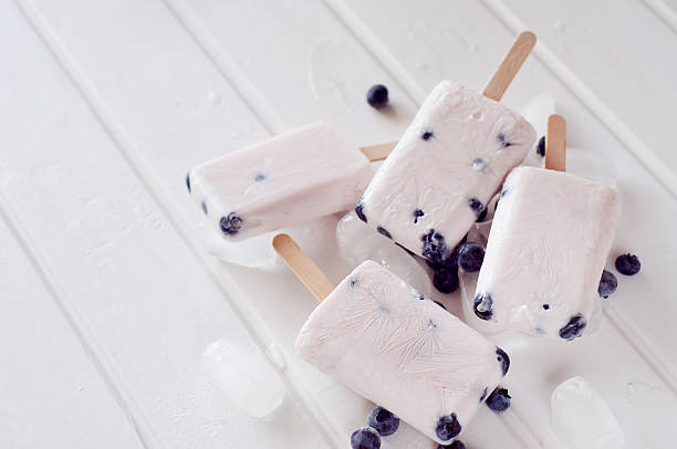 istock Ice popsicles with yogurt and blueberries in ice lolly mold 585283356