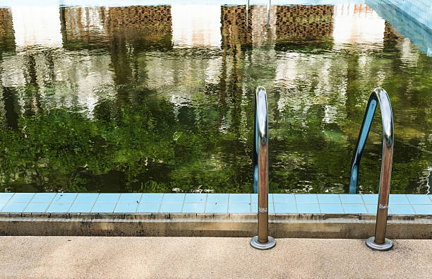 istock Old abandoned swimming pool with dirty water 585285824