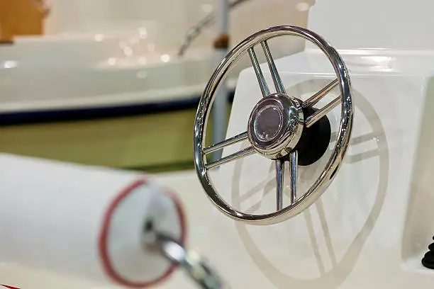 new powerful chrome steering wheel for boat; note shallow depth of field