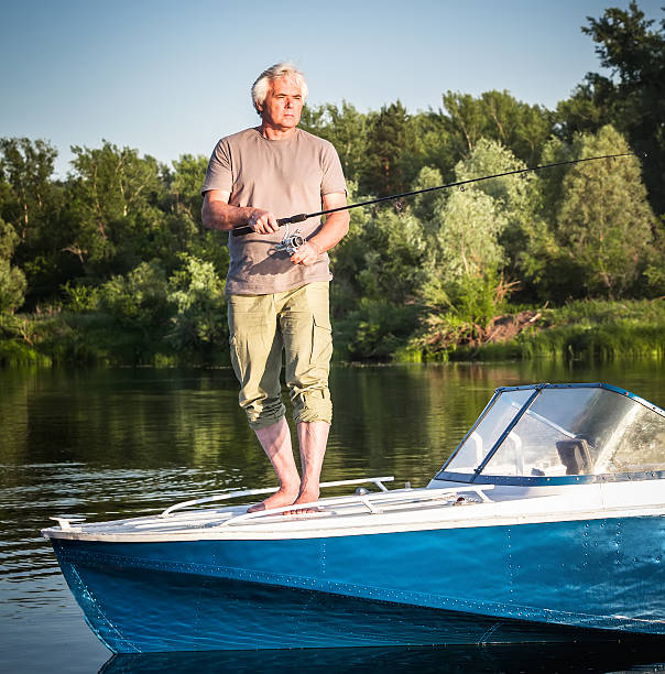 istock Mature man on a motor boat. Fishing. 585288428