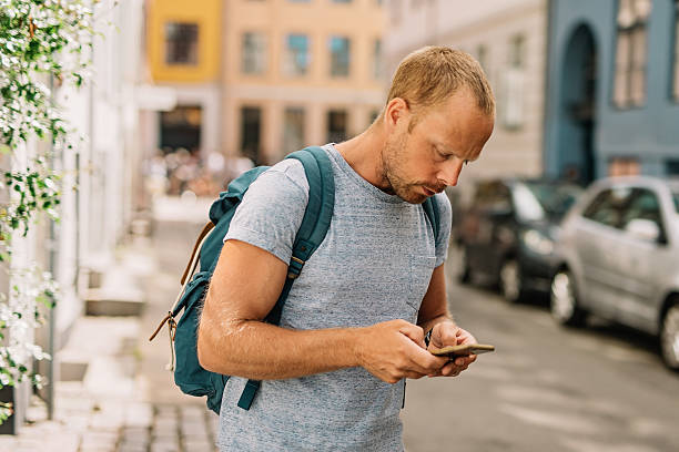 istock Man playing mobile game on his phone looking down 585289598