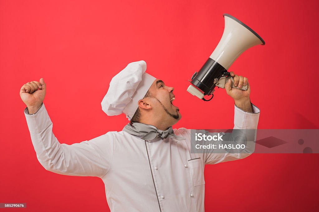 Portrait of caucasian man with chef uniform holding megaphone Chef Stock Photo
