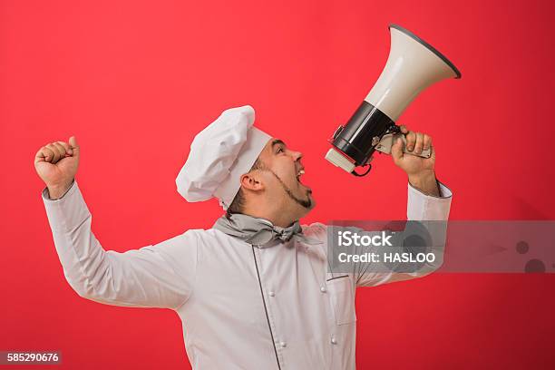 Portrait Of Caucasian Man With Chef Uniform Holding Megaphone Stock Photo - Download Image Now