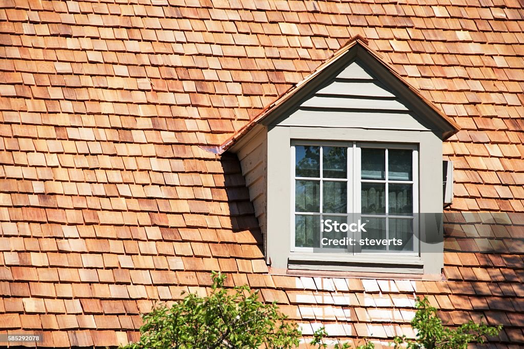 Cedar Dormer Dormer in roof of house with cedar shingles. Rooftop Stock Photo