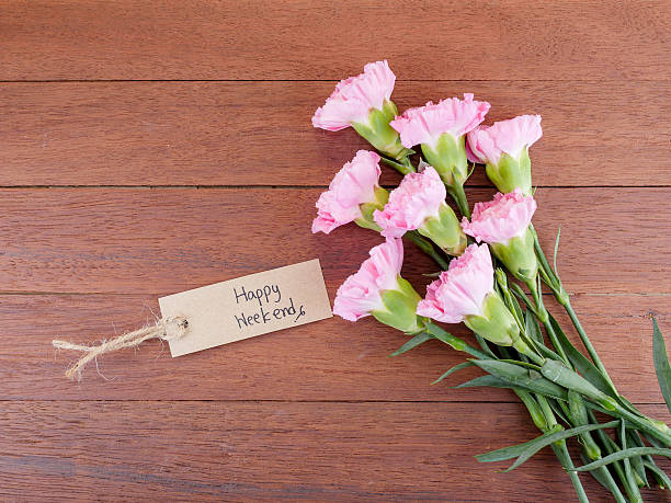 istock Handwriting Happy Weekend and Carnation flower 1 585297358