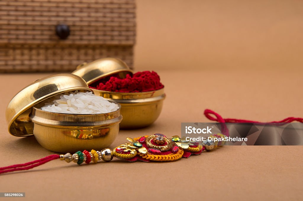 Indian festival: Raksha Bandhan, Rakhi. Raakhi and a gift for the sister given by brother on the occasion of Raksha Bandhan. A traditional Indian wrist band which is a symbol of love between Brothers and Sisters. Raksha Bandhan Greeting. Rakhi Stock Photo
