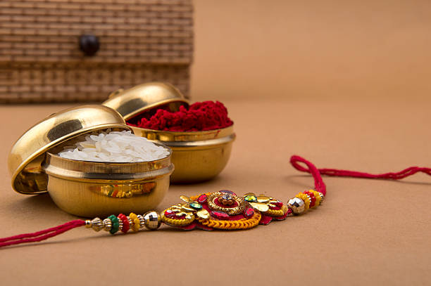 Indian festival: Raksha Bandhan, Rakhi. Raakhi and a gift for the sister given by brother on the occasion of Raksha Bandhan. A traditional Indian wrist band which is a symbol of love between Brothers and Sisters. Raksha Bandhan Greeting. raksha bandhan stock pictures, royalty-free photos & images