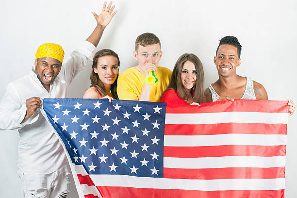 istock Group of multiracial people holding a american flag 585298906