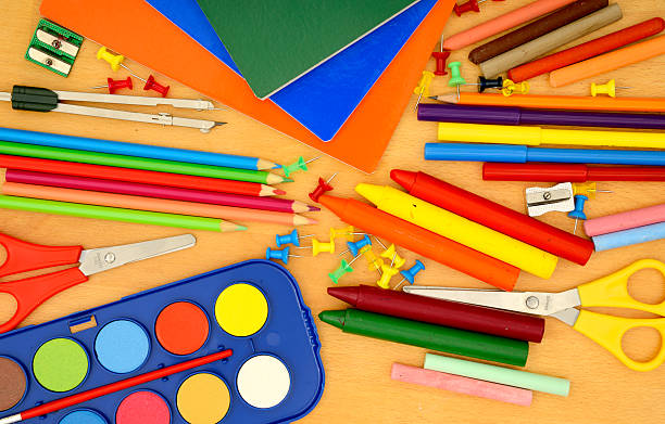 istock School supplies on wooden desk 585299370
