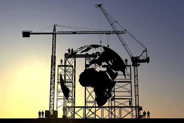 Globe construction site Globe icon construction site silhouette with cranes and steel structures better world stock pictures, royalty-free photos & images