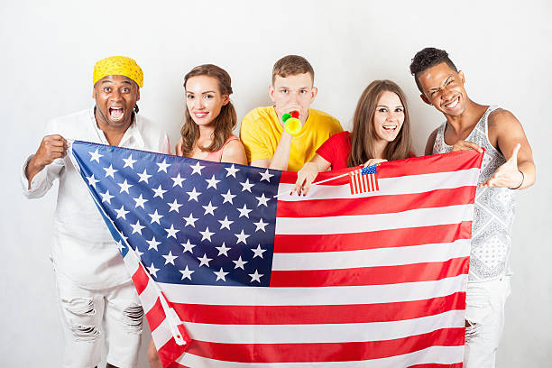 istock Group of multiracial people holding a american flag 585299736