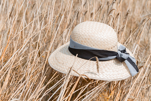 Straw hat on the golden wheat field