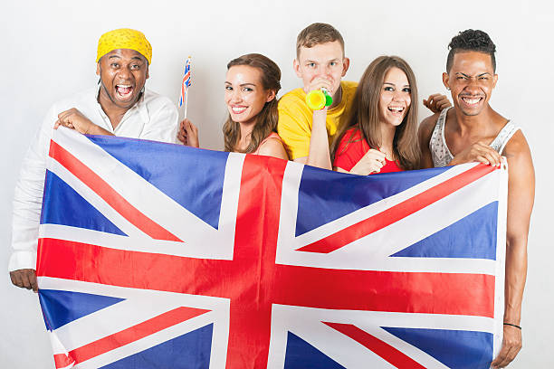 istock Group of multiracial people holding a England flag 585299902