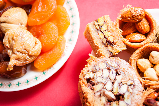 dried fruit and Eastern Turkish delights on a red background. baklava, burma baklava, Mebrume.