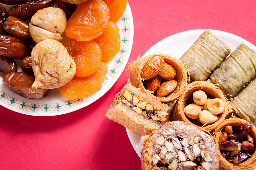 dried fruit and Eastern Turkish delights on a red background. baklava, burma baklava, Mebrume.