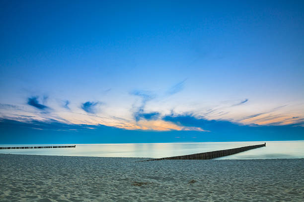 istock Warm sunset over sand beach on Baltic sea in Poland. 585300462