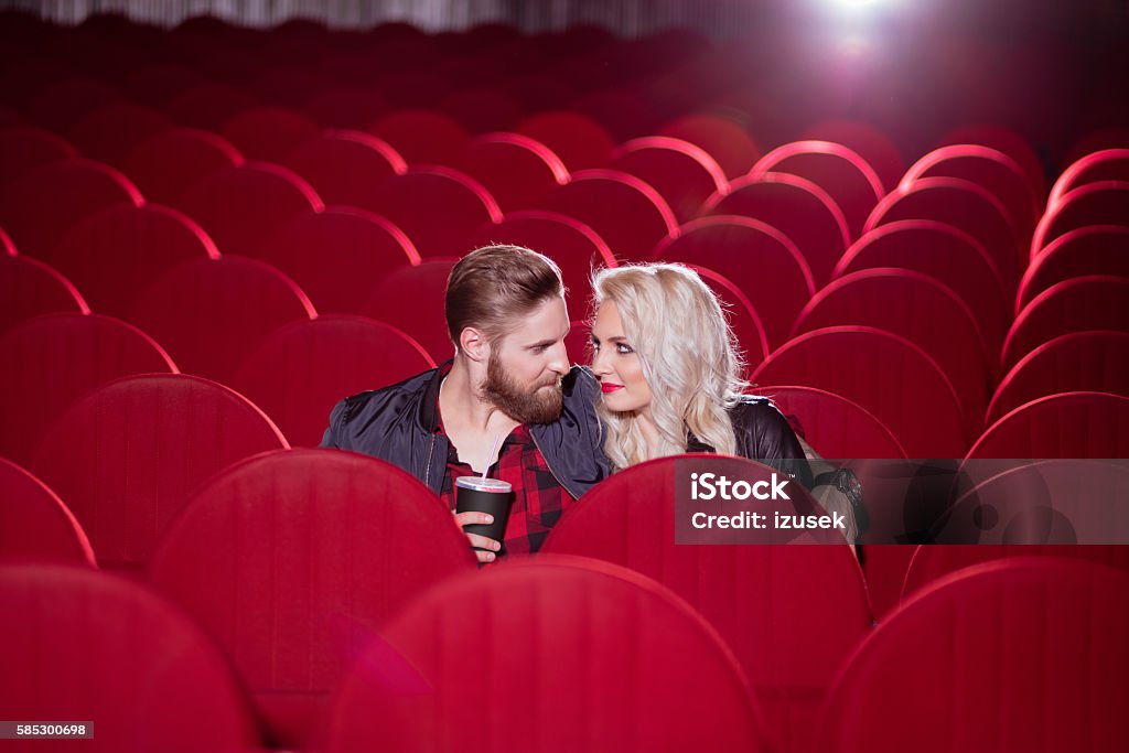 Young couple in the cinema Young couple dating in the movie theater. Adult Stock Photo