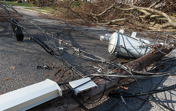 Power outage from storm Tree falls after Nor-easter storm and takes down a telephone pole with Transformer. no power in this area utility pole with power lines close up stock pictures, royalty-free photos & images