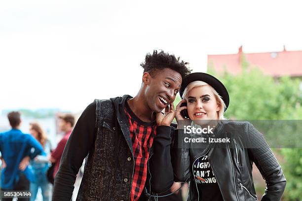 Afro American Young Guy And Blonde Girl Using Mobiles Outdoor Stock Photo - Download Image Now