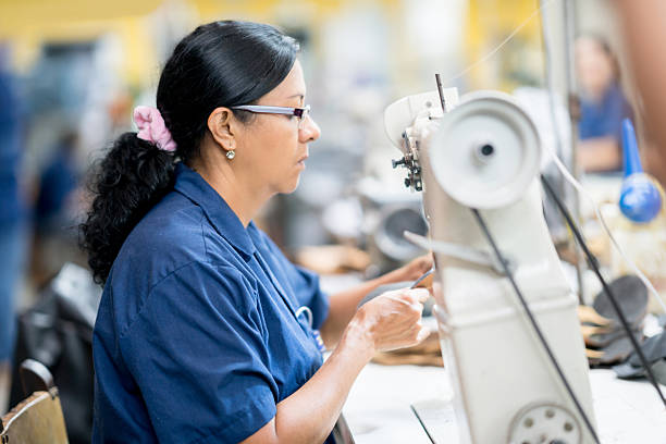 istock Female worker making shoes at a factory 585304748