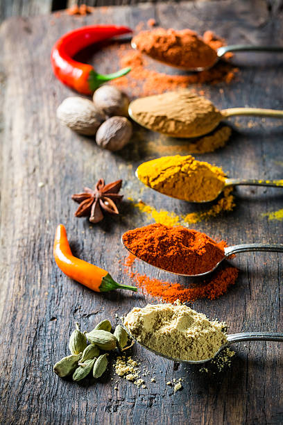 istock Tasty herbs and spices on old spoons 585304910